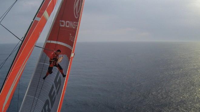 Onboard Dongfeng Race Team - Eric Peron spends the morning up the mast fixing a small hole in the MH0 - Leg 8 to Lorient – Volvo Ocean Race 2015 © Yann Riou / Dongfeng Race Team